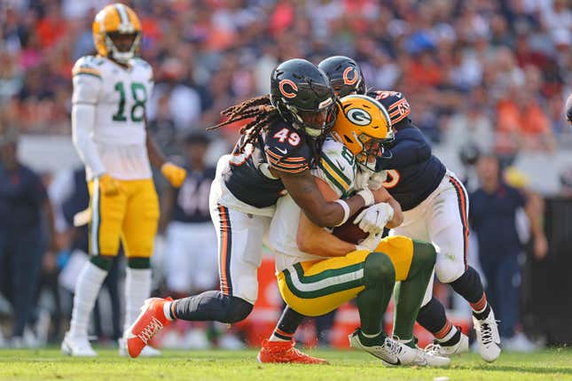 CHICAGO, ILLINOIS - SEPTEMBER 10:  Luke Musgrave #88 of the Green Bay Packers is tackled by Tremaine Edmunds #49 and T.J. Edwards #53 of the Chicago Bears during the first half at Soldier Field on September 10, 2023 in Chicago, Illinois. (Photo by Michael Reaves/Getty Images)