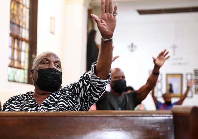 Parishioners worship during Sunday Mass at St. Augustine Catholic Church on August 15, 2021, in New Orleans, Louisiana.