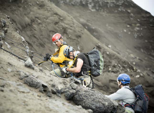 (L to R): Will Smith, Vulcanologist Jeff Johnson and Explorer Erik Weihenmayer descend into a volcano to install sensors. (National Geographic for Disney+/Kyle Christy)