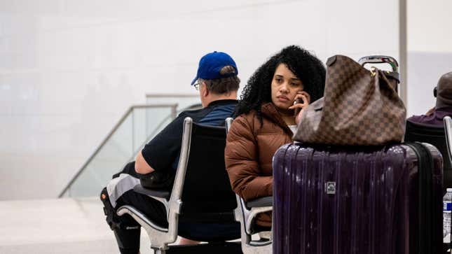 HOUSTON, TEXAS - DECEMBER 27: Travelers wait in the lobby at George Bush Intercontinental Airport on December 27, 2022 in Houston, Texas. Southwest Airlines has canceled approximately 5,400 flights in less than 48 hours due to a variety of issues including this year’s historic winter storm and scheduling complications involving crew members. 