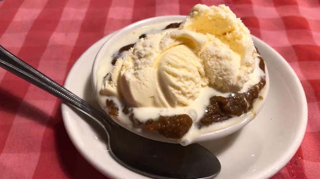 Indian pudding in bowl on red tablecloth