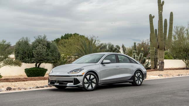 A gray Ioniq 6 parked in front of a big cactus