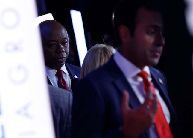 MIAMI, FLORIDA - NOVEMBER 08: Republican presidential candidate U.S. Sen. Tim Scott (R-SC) speaks to members of the media as he is seen behind fellow candidate Vivek Ramaswamy in the spin room following the NBC News Republican Presidential Primary Debate at the Adrienne Arsht Center for the Performing Arts of Miami-Dade County on November 8, 2023 in Miami, Florida. Five presidential hopefuls squared off in the third Republican primary debate as former U.S. President Donald Trump, currently facing indictments in four locations, declined again to participate.