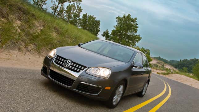 A photo of a gray VW Jetta sedan. 