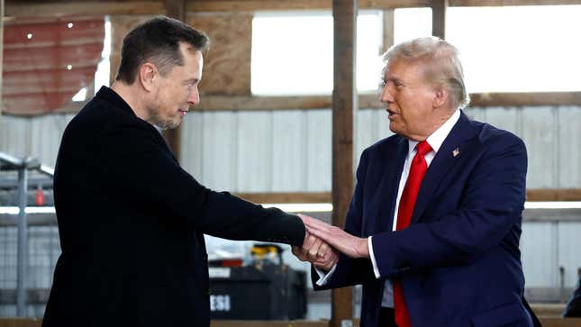 Elon Musk shakes hands with Donald Trump