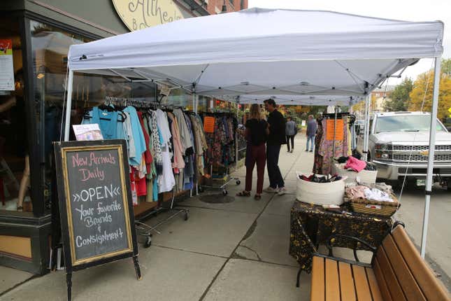 Shoppers stop at a sidewalk sale at Althea&#39;s Attic Boutique in Montpelier, Vt., on Friday, Oct. 6, 2023. Three months after flooding inundated the small city, Montpelier is holding a reopening celebration on Friday and Saturday to show the progress. (AP Photo/Lisa Rathke)