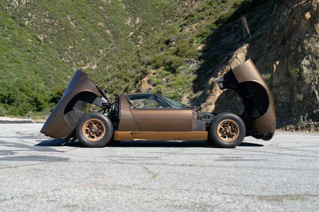 Side view of a brown Lamborghini Miura P400 S with the clamshells open