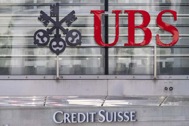 FILE - The logos of the Swiss banks Credit Suisse and UBS are pictured in Zurich, Switzerland, June 12, 2023. UBS on Tuesday, Feb. 6, 2024 reported a fourth-quarter pretax loss of more than $750 million as the Swiss banking giant continued to integrate its longtime rival Credit Suisse after a government-orchestrated merger. (Ennio Leanza/Keystone via AP, File)