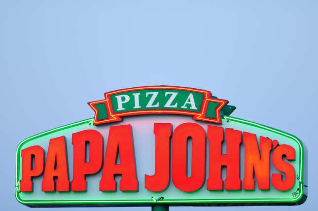 A Papa Johns Pizza Sign at sunset on University Drive in Huntsville, Alabama.
