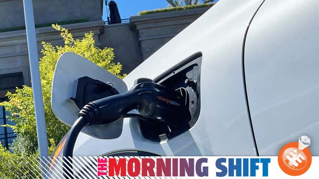 Close up of an electric vehicle's charging port with a charger plugged in.