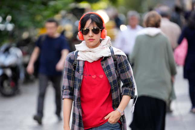 A woman without wearing her mandatory Islamic headscarf walks in downtown Tehran, Iran, Saturday, Sept. 9, 2023. Iranians are marking the first anniversary of nationwide protests over the country&#39;s mandatory headscarf law that erupted after the death of a young woman detained by morality police. (AP Photo/Vahid Salemi)