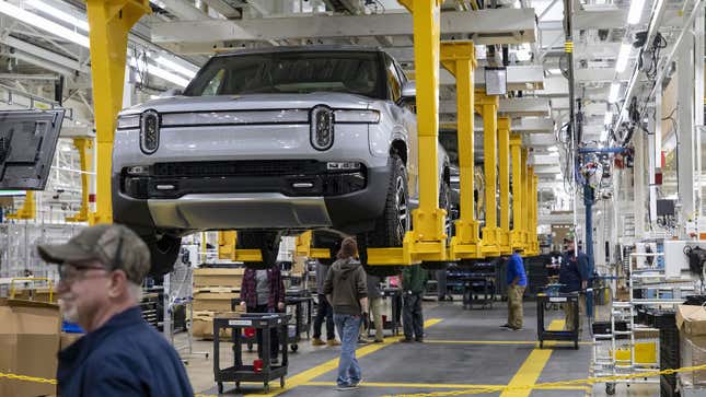 A photo of a Rivian being assembled at a factory. 