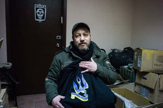 Leonid Krasnopolsky shows off one of his t-shirt designs, which reads “Glory to the heroes!”