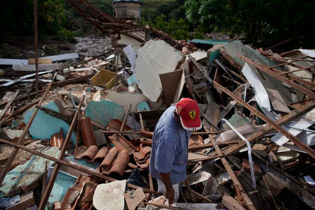 On Jan. 26, 2019, man stands in the debris of his home, which was destroyed after a dam collapsed in Brumadinho, Brazil a day earlier.