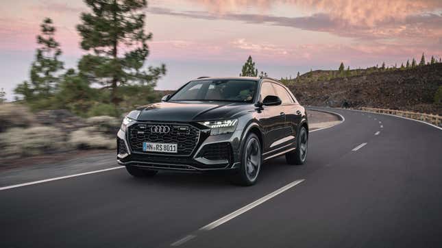 A Daytona grey Audi RS Q8 driving on a road