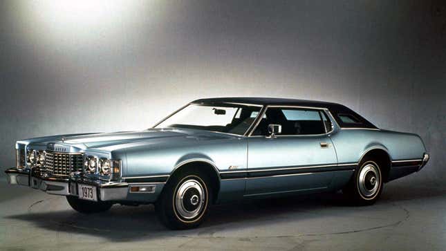 A photo of a blue, vintage Ford Thunderbird car. 