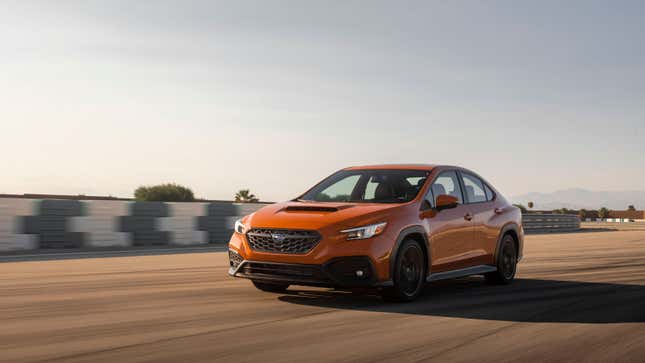 A photo of an orange Subaru WRX. 