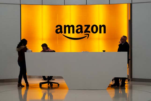 FILE - People stand in the lobby for Amazon offices in New York, Feb. 14, 2019. Britain&#39;s cloud computing market faces a competition investigation after regulators raised concerns about the dominance of two tech giants, Amazon and Microsoft. The U.K. communications regulator Ofcom said Thursday, Oct. 5, 2023 that its year-long study of the cloud communications services market found features that could limit competition. British businesses face barriers when they try to switch or use multiple cloud suppliers, it said. (AP Photo/Mark Lennihan, File)