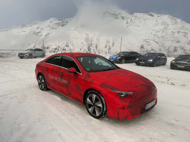 Front 3/4 view of a camouflaged Mercedes-Benz CLA EV prototype