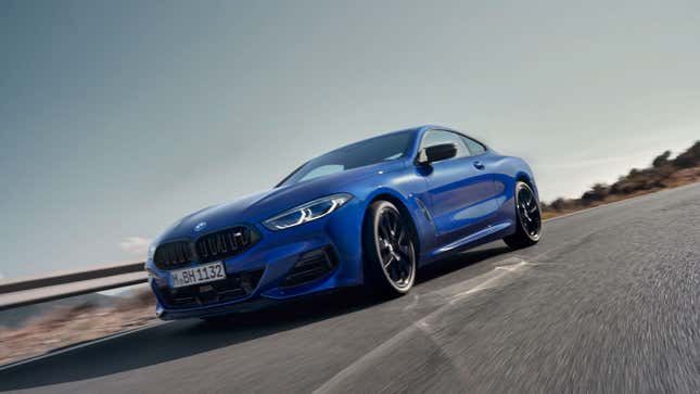 A photo of a blue 8 Series BMW driving on a track. 