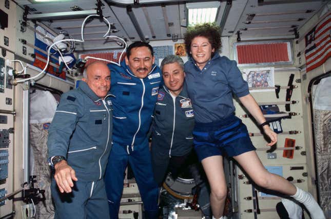 Space tourist Dennis Tito poses with cosmonauts and astrronauts onboard the International Space Station in 2001.