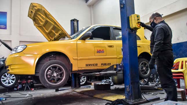 A car is lifted up on jacks by a mechanic 