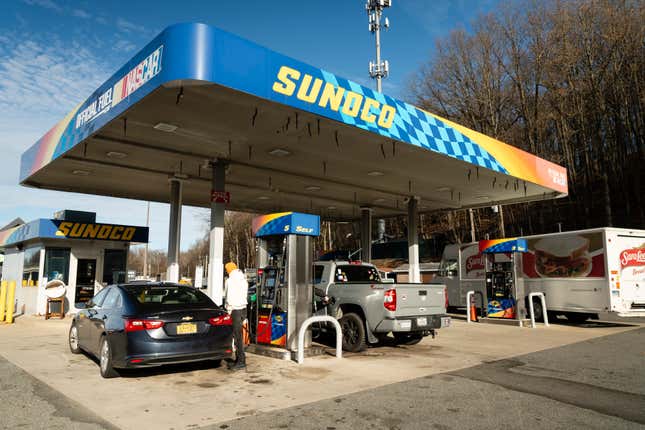 A customer refuels at a Sunoco gas station along Interstate 87 in Hastings-On-Hudson, New York, US, on Friday, Dec. 22, 2023. 