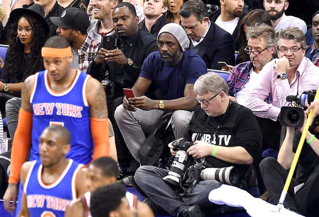 LONDON, ENGLAND - JANUARY 15: Idris Elba (C) attends the NBA Global Games match between New York Knicks and Milwaukee Bucks at 02 Arena on January 15, 2015 in London, England. (Photo by Karwai Tang/WireImage)