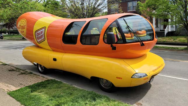 The Oscar Mayer Wienermobile parked on a residential street.