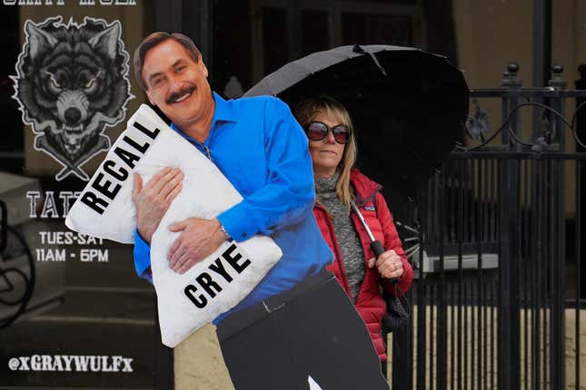 Stacy Oliver holds display of Mike Lindell, the controversial CEO of My Pillow who has advocated falsehoods about the 2020 presidential election, during a rally in Redding, Calif., on Tuesday, Feb. 20, 2024. Oliver supports recalling Shasta County Supervisor Kevin Crye from office. Crye is one of the board members who voted to get rid of the county&#39;s ballot-counting machines in favor of counting ballots by hand. Crye had previously met with Lindell, an action that angered some voters. (AP Photo/Rich Pedroncelli)