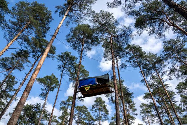 A view of tree houses set up by activists near the Tesla Gigafactory for electric cars in Gruenheide near Berlin, Germany, Tuesday, March 5, 2024. Production at Tesla&#39;s electric vehicle plant in Germany came to a standstill and workers were evacuated after a power outage that officials suspect was caused by arson. The interior ministry in the state of Brandenburg says unidentified people are suspected of deliberately setting fire to a high-voltage transmission line on a power pylon. (AP Photo/Ebrahim Noroozi)