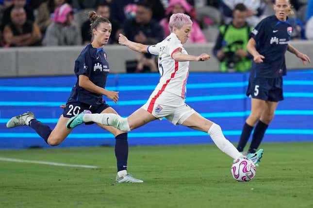 OL Reign forward Megan Rapinoe, center, passes the ball as San Diego Wave defender Christen Westphal defends during the second half of an NWSL semifinal playoff soccer match Sunday, Nov. 5, 2023, in San Diego. (AP Photo/Gregory Bull)