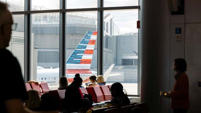 Customers wait to board an American Airlines flight