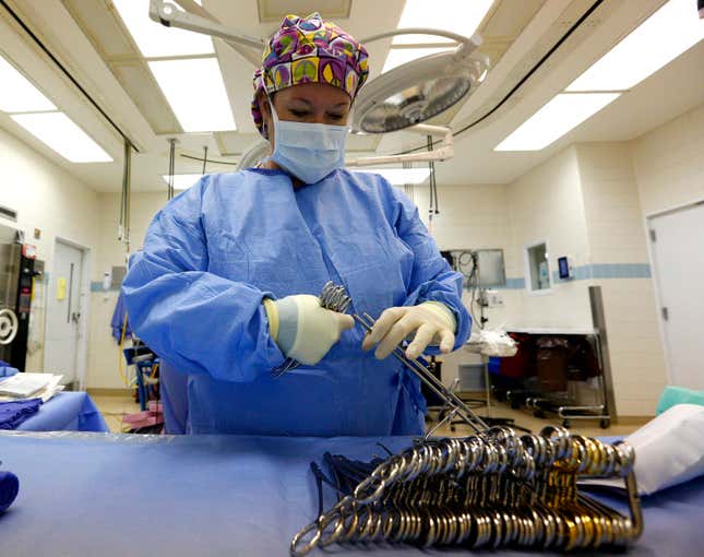 A surgical tech prepares an OR room in the University of Mississippi Medical Center in Jackson, Mississippi. Direct-care jobs in healthcare are still hiring.