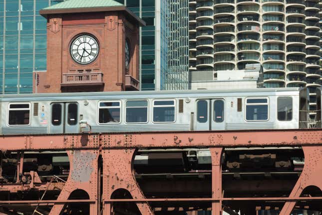 An elevated train passes buildings in downtown Chicago.