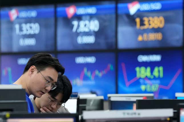 Currency traders work at the foreign exchange dealing room of the KEB Hana Bank headquarters in Seoul, South Korea, Thursday, March 7, 2024. Asian shares were mostly higher in early Thursday trading, after Wall Street recovered some losses from the day before. (AP Photo/Ahn Young-joon)