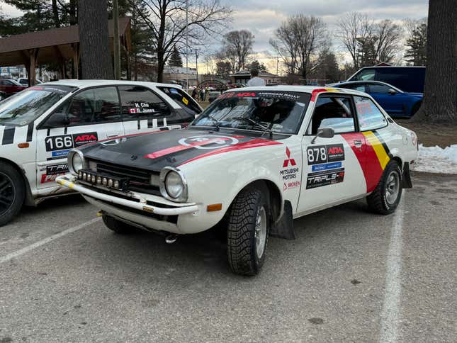 Vista frontal de 3/4 de un auto de rally Dodge Colt blanco