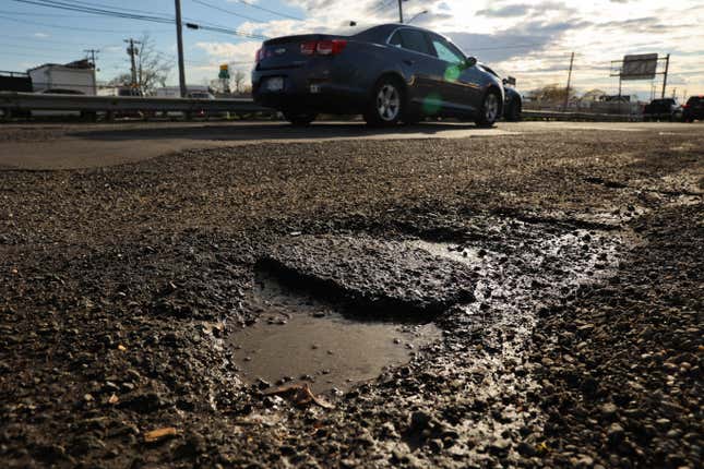 East Farmingdale, N.Y.: Vehicles pass over a rough roadway with potholes on Route 109, westbound, near E. Carmans Road in East Farmingdale, New York on April 19, 2022. 