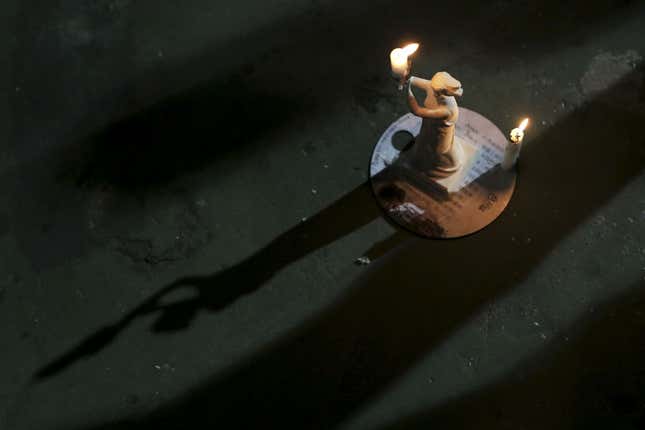 A miniature Goddess of Democracy candlestick is displayed during a candlelight vigil in Hong Kong