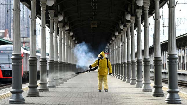 A serviceman of Russia’s Emergencies Ministry wearing protective gear disinfects Moscow’s Belorussky railway station on October 20, 2021.