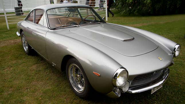 A photo of a silver Ferrari 250GT Lusso sports car. 