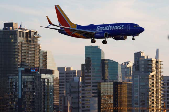 An illustration of a Southwest Airlines plane flying low over skyscrapers