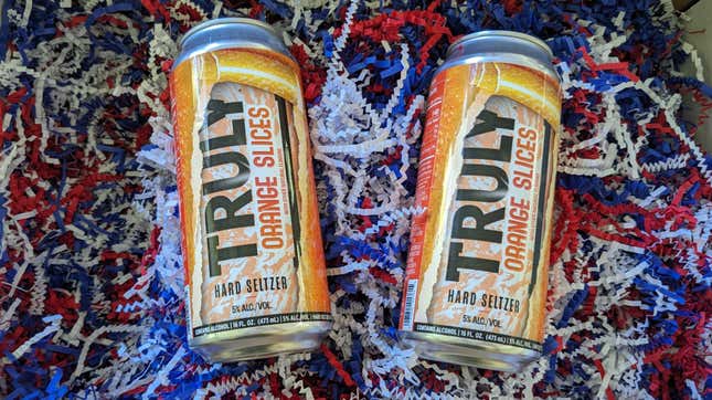 two cans of Truly Hard Seltzer in new Orange Slices flavor