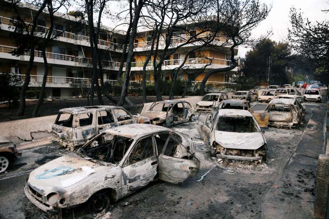 Burned cars are seen following a wildfire in the village of Mati, near Athens.