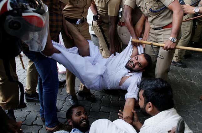 Police remove protesters in Kochi.