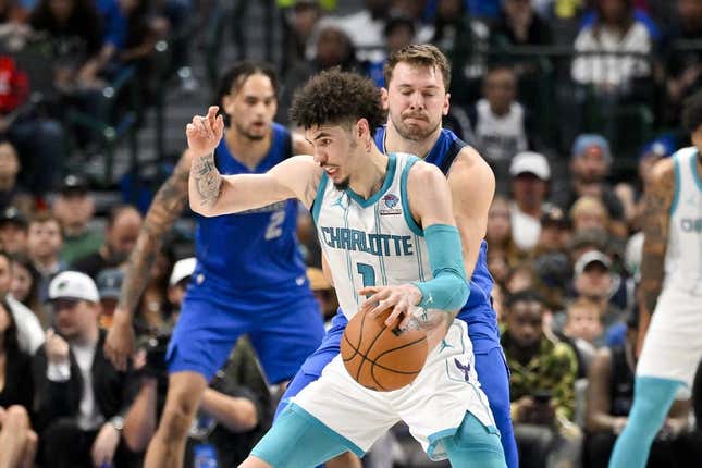 Nov 5, 2023; Dallas, Texas, USA; Dallas Mavericks guard Luka Doncic (77) attempts to knock the ball away from Charlotte Hornets guard LaMelo Ball (1) during the second quarter at the American Airlines Center.