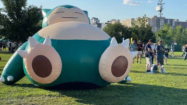 A Snorlax balloon is shown next to Pokemon Go Fest attendees.