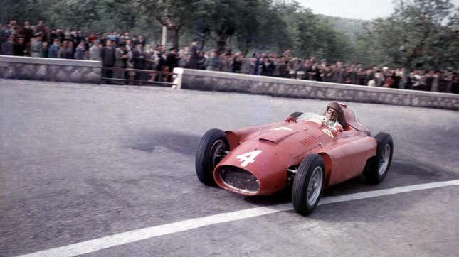 Juan Manuel Fangio takes a corners in his Ferrari-Lancia D50 on his way to another victory at the The Syracuse Grand Prix, Syracuse, 15th April 1956.