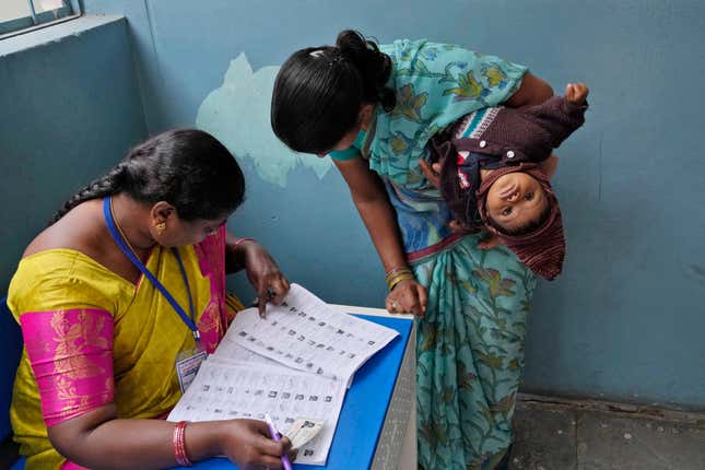 FILE - A woman checks for her name before casting her vote at a polling station during the Telangana state assembly elections in Hyderabad, India, Nov. 30, 2023. From April 19 to June 1, nearly 970 million Indians - or over 10% of the world’s population - will vote in the country&#39;s general elections. It&#39;s one of several high-profile elections around the world this year that are highlighting concerns about online election misinformation. (AP Photo/Mahesh Kumar A., File)