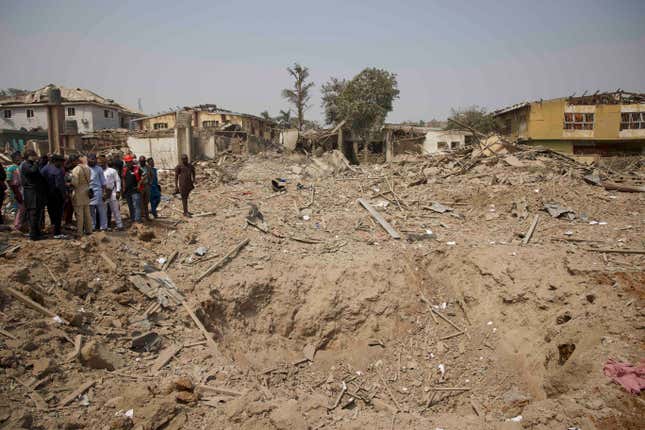 People gather near a crater at the site of an explosion in Ibadan, Nigeria, Wednesday, Jan. 17, 2024. Several people died and many others were injured after a massive blast caused by explosives rocked more than 20 buildings in one of Nigeria&#39;s largest cities Tuesday night, authorities said Wednesday, as rescue workers dug through the rubble in search of those feared trapped. (AP Photo)